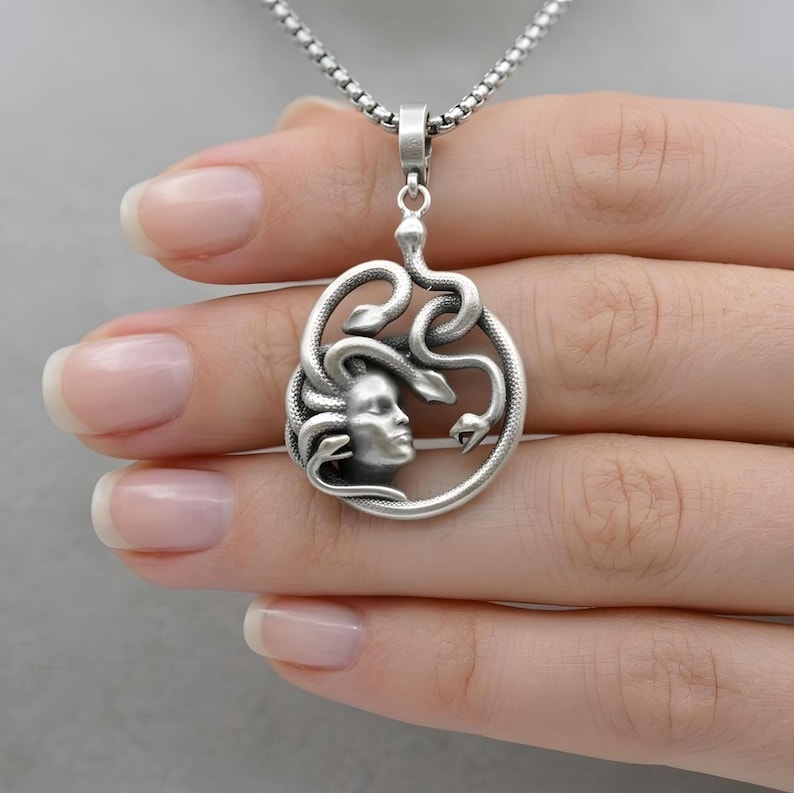 Handmade Medusa necklace in antique silver plated finish. The dark silver tones highlight the intricate details of the snakes and Medusa's face. Bohemian style mythological jewelry, spiritual protector gift.