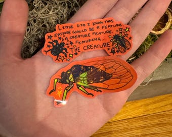May include: Two stickers featuring a creature with the text "Little did I know this episode would be a feature. A creature feature. Featuring... The Creature."