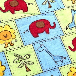 Jungle Flannel featuring red yellow blue elephants lions giraffes on green and blue background nursery decor projects