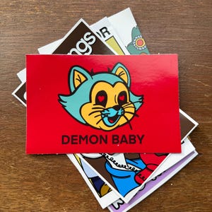 Demon Baby Cat Vinyl Sticker | Funny Cartoon Glossy Sticker for Laptop or Water Bottle