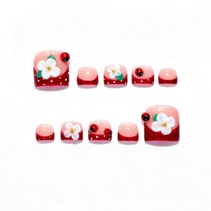 May include: A set of ten press-on toenails featuring a red base with white polka dots and a French tip style. The nails are decorated with three-dimensional white flowers with yellow centers, green leaves, and small red ladybug embellishments.