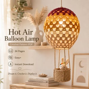 May include: A crocheted hot air balloon lamp with a brown basket holding a small bunny. The balloon is a gradient of brown, yellow, and red. The text reads "Hot Air Balloon Lamp Crochet Pattern PDF".