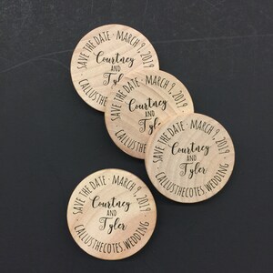 May include: Four round wooden save the date magnets with the text "Save the Date - March 9, 2019 - Courtney and Tyler - Callusthecotes. Wedding"