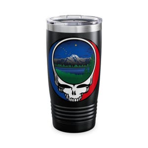 May include: A black stainless steel tumbler with a colorful graphic of a mountain scene inside a stylized skull. The skull is surrounded by a red, white, and blue circle.