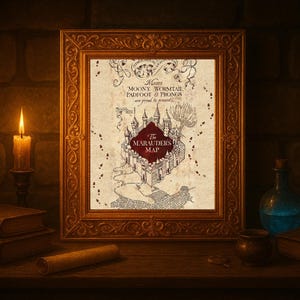May include: A framed print of The Marauder's Map, featuring a detailed map design with text. The frame is ornate and gold-colored. A lit candle, books, and a potion bottle are on a wooden surface.