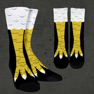 May include: A pair of black socks with a white and blue pattern on the top and yellow chicken legs and feet extending from the sock.