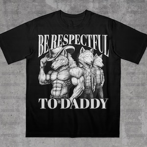 May include: Black t-shirt with a graphic of three wolf-like figures. The central figure is muscular and wearing a hat. The text "BE RESPECTFUL TO DADDY" is printed in white above and below the illustration.