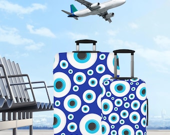 Niebieski pokrowiec na bagaż Evil Eye. Ochronny pokrowiec podróżny. Dostępny w 3 rozmiarach. Akcesorium podróżne. Prezent na wakacje.
