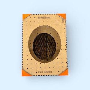 Puede incluir: Un marco rectangular de madera con un recorte circular, que muestra un interior texturizado. El marco tiene pequeños agujeros espaciados uniformemente y detalles en naranja en las esquinas. Dimensiones: 265 x 970 mm y 196 x 226 mm.
