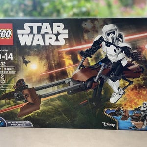 May include: A LEGO Star Wars set featuring a Scout Trooper on a Speeder Bike. The box shows the figure in white and black armor riding a brown and gray speeder bike. The set includes 452 pieces and is for ages 10-14.