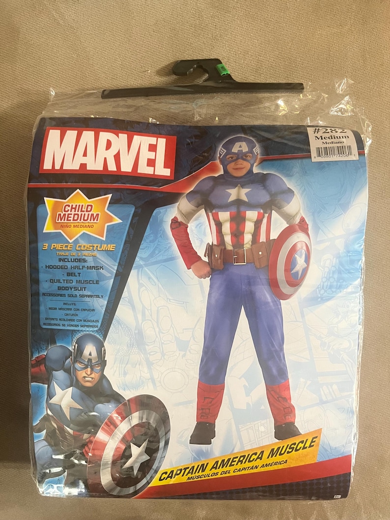 May include: A packaged Captain America child's costume. The costume includes a hooded half-mask, belt, and quilted muscle bodysuit. The packaging features the Marvel logo and an image of Captain America holding his shield.