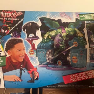 May include: Spider-Man Into the Spider-Verse playset featuring Miles Morales figure and Green Goblin. The box art includes the text "Super Collider Playset" and images of characters from the movie.