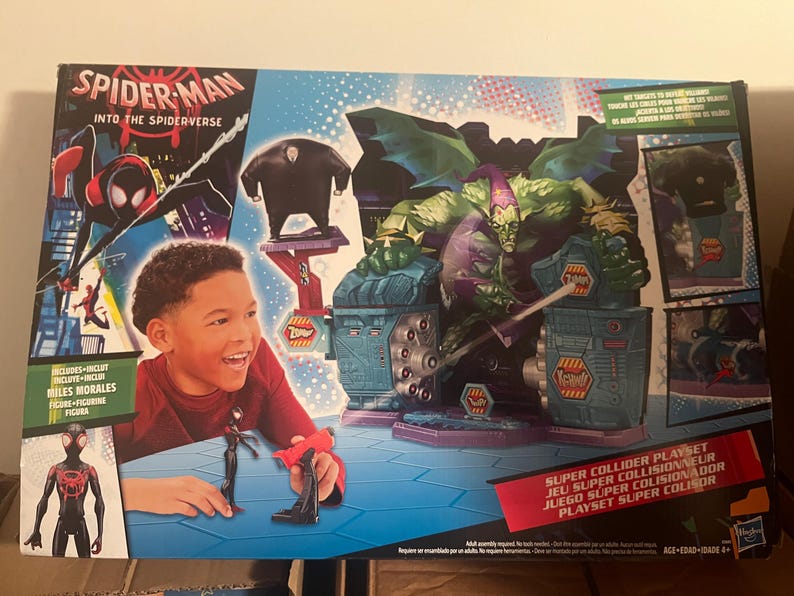 May include: Spider-Man Into the Spider-Verse playset featuring Miles Morales figure and Green Goblin. The box art includes the text "Super Collider Playset" and images of characters from the movie.