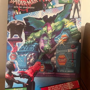 May include: A Spider-Man Into the Spider-Verse Super Collider Playset box. The box features illustrations of Spider-Man, Miles Morales, and the Green Goblin. The playset includes a Miles Morales figure and targets to defeat villains.