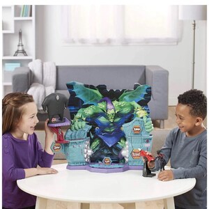 May include: A Green Goblin playset featuring a large Green Goblin figure with a purple and green color scheme. The playset has a blue and purple base with two children playing with the toys.