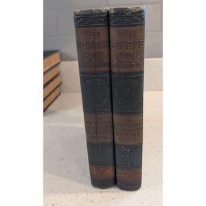 May include: Two antique books with brown and black covers. The spines read "THE SOURCE BOOK ENCYCLOPEDIC" and "AND PERPETUAL LOOSE LEAF EXTENSION SERVICE". The books are standing upright on a light-colored surface.