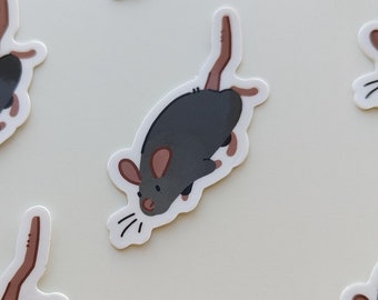 May include: A collection of stickers featuring a cartoon rat design. Each sticker has a dark gray body, pink ears, and a long brown tail. The rat is depicted in a running pose with white whiskers.