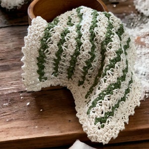 three crochet dishcloths that have a Lacey vintage farmhouse look  green and cream striped with cream trim