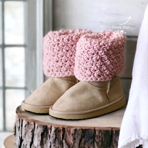 textured pink crochet boot cuffs, toppers, spats rolled over to cover the top of the boots that look like beige ugg boots