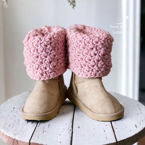 textured pink crochet boot cuffs, toppers, spats rolled over to cover the top of the boots that look like beige ugg boots