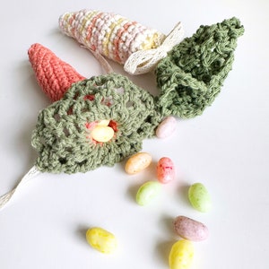 crochet carrots with green lacey tops in different colours for crochet carrot pattern.treats coming out of carrots