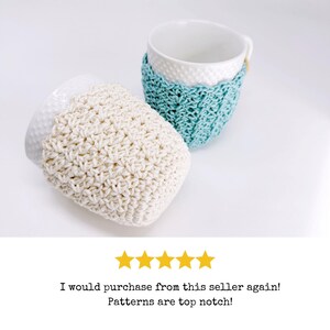 May include: Two white ceramic mugs with crocheted cozies. One cozy is off-white, the other is light blue. The off-white cozy is lying on its side, while the light blue cozy is wrapped around a mug. The text says "I would purchase from this seller again! Patterns are top notch!"
