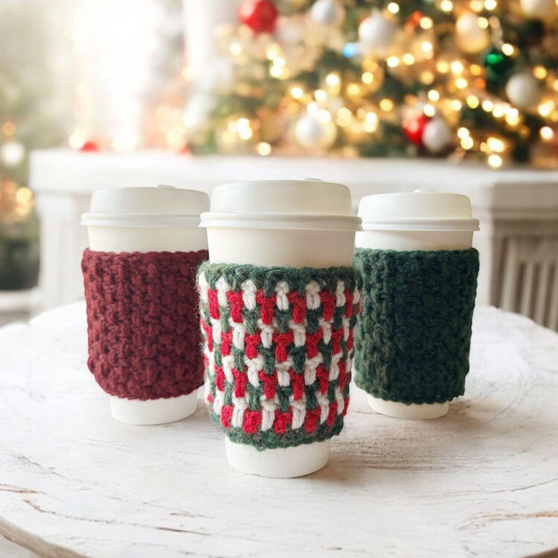 group of crochet cup cozies that look knit christmas tree in the background