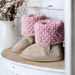 textured pink crochet boot cuffs, toppers, spats rolled over to cover the top of the boots that look like beige ugg boots