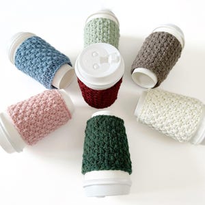 group of crochet cup cozies that look knit