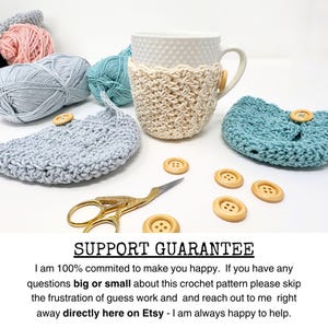 May include: A cream-colored crocheted mug cozy with a wooden button, paired with a matching coaster. The image also shows light blue and pink yarn balls, wooden buttons, and gold scissors. The text reads "SUPPORT GUARANTEE".