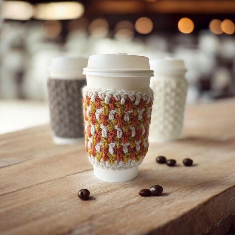 group of crochet cup cozies that look knit in a coffee shop