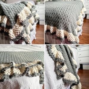 a green crocheted blanket  with cream crochet border sits on a bed