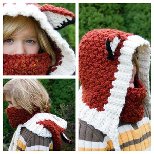 May include: A red and white crocheted fox hat and scarf set. The hat has a pointed hood with fox ears and the scarf is a cowl style.