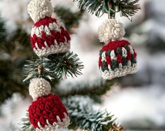 May include: Three crocheted Christmas ornaments shaped like winter hats with pom-poms. The hats are red, green, and white.