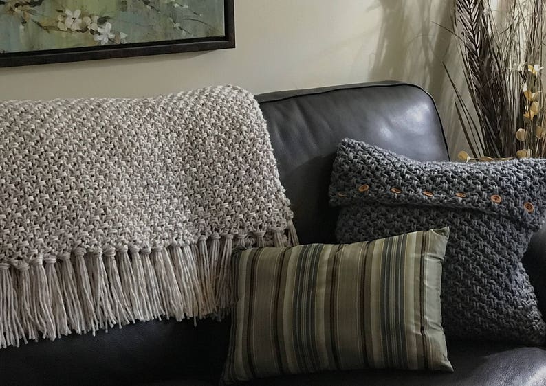 Beige crochet blanket with fringe that looks knit.  It is a throw size meaning it will cover legs and part of body not big enough for bed.  This is a crochet pattern not a finished item.