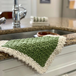 three crochet dishcloths that have a Lacey vintage farmhouse look  green with cream trim