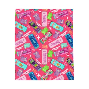 May include: A pink and white patterned fabric with a repeating design of colorful cans with the text "Alani Energy Break" and "Alani" on them.