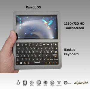Könnte beinhalten: Handheld-Gerät mit Hintergrundbeleuchtung und 1280x720 HD-Touchscreen. Der Bildschirm zeigt ein farbenfrohes Papageienbild. Das Gerät ist mit "Parrot OS" beschriftet.