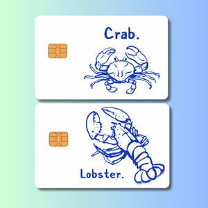 May include: Two white cards with blue illustrations of a crab and a lobster. The word "Crab" is above the crab illustration, and "Lobster" is below the lobster illustration. Each card has a gold-colored chip.