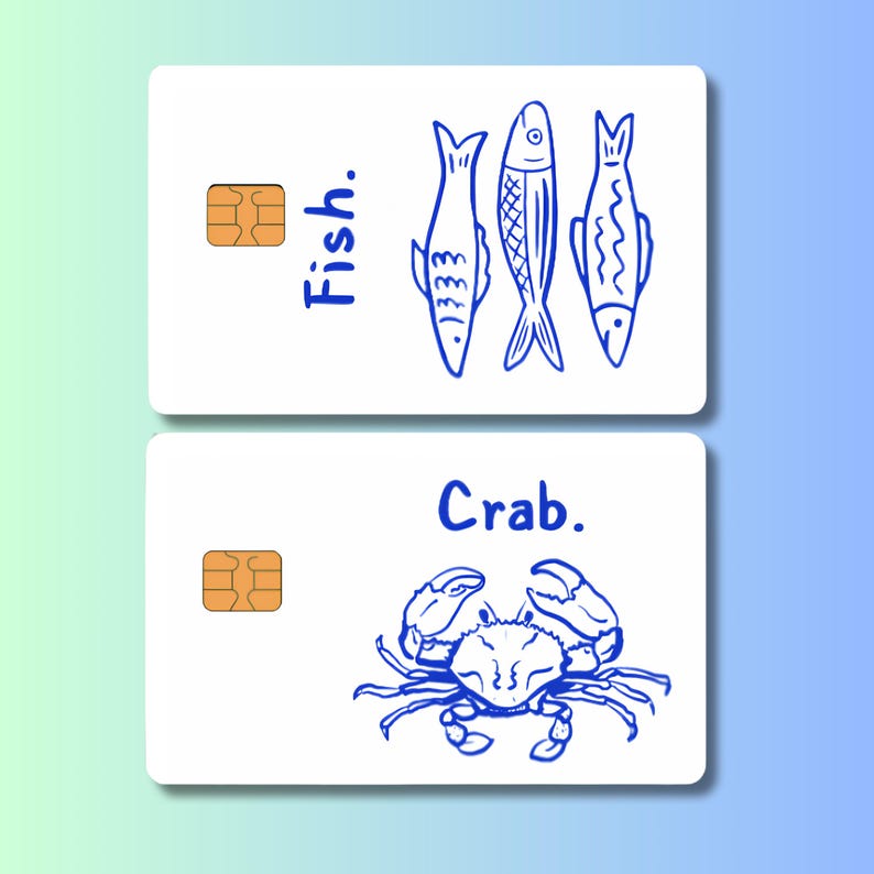 May include: Two white cards with blue illustrations and text. The top card says "Fish." and features three fish drawings. The bottom card says "Crab." and shows a crab drawing. Each card has a gold-colored chip.
