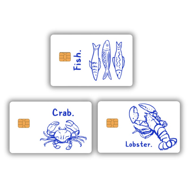 May include: Three white cards with blue illustrations of sea creatures. One card has three fish and the word "Fish.", another has a crab and the word "Crab.", and the last has a lobster and the word "Lobster."