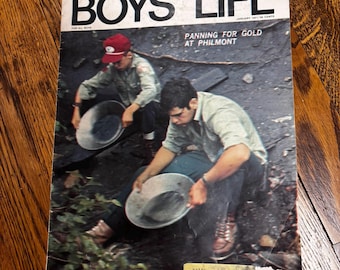 May include: Vintage Boys' Life magazine cover featuring two people panning for gold at Philmont. The magazine's title, "BOYS' LIFE," is prominently displayed. The cover also includes the text "PANNING FOR GOLD AT PHILMONT" and "FOR ALL BOYS."