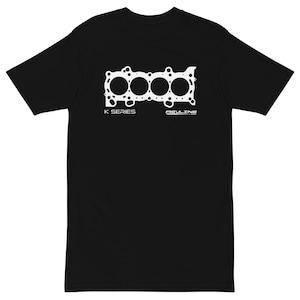 Puede incluir: Camiseta negra con un gráfico blanco de un componente del motor. El diseño muestra cuatro aberturas circulares y el texto "K SERIES" y "REVLINE" en blanco. La camiseta está hecha de un material suave.