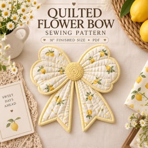 May include: A quilted fabric bow with a yellow lemon print and a central yellow circular knot. The text reads QUILTED FLOWER BOW SEWING PATTERN, 10" FINISHED SIZE, PDF, and SWEET DAYS AHEAD. The bow features stitched grid lines and yellow trim.