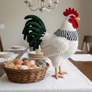 May include: A large, handmade crochet rooster with a white body, black and white striped neck, and a red comb and wattle. The rooster stands next to a wicker basket filled with eggs, some decorated. The rooster's tail is green. The scene is set on a table.