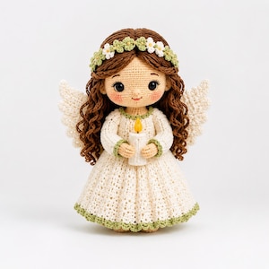 May include: A handcrafted crochet angel doll with brown curly hair, a floral crown, and cream-colored wings. The doll wears a cream-colored dress and holds a candle with a yellow flame. The dress and trim have green accents.