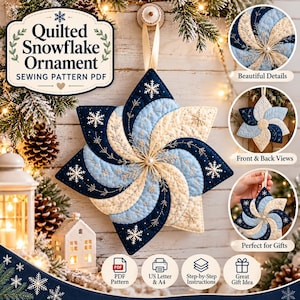 May include: A quilted snowflake ornament sewing pattern PDF featuring a star-shaped design with navy blue, light blue, and cream fabric segments. The ornament has intricate white snowflake embroidery, a central pearl bead, and a cream ribbon for hanging.