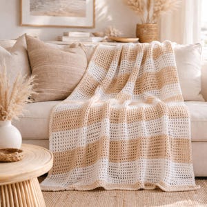 May include: A set of three ceramic nesting bowls in graduating sizes. The bowls feature a speckled, matte finish in shades of cream, light brown, and dark brown. The largest bowl measures approximately 8 inches in diameter.