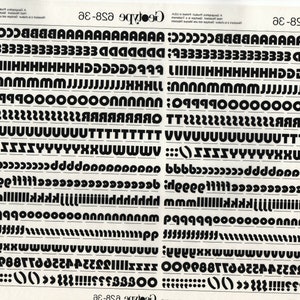 May include: A black and white typography chart with a variety of uppercase letters, numbers, and punctuation marks. The chart is titled "GeoType 628-36".