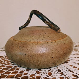 May include: A set of three ceramic mugs with a speckled, matte finish. Each mug features a different color: light blue, cream, and gray. The mugs have a simple, modern design and a comfortable handle.